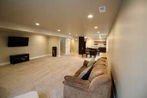 Living room featuring light carpet