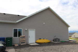 Rear view of house featuring central air condition unit