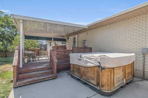 View of patio / terrace with a wooden deck and a hot tub