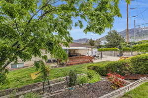 View of yard with a deck with mountain view