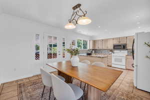 Dining space featuring ornamental molding and light tile patterned floors