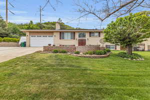 View of front of property with a garage and a front yard