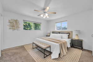 Carpeted bedroom featuring ornamental molding and ceiling fan