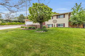 View of front of home featuring a garage and a front lawn