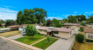 View of front of house featuring a garage and a front yard