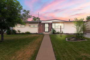 Ranch-style home with a yard