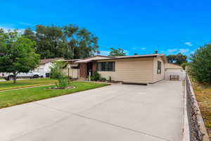 Ranch-style home featuring a front lawn