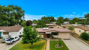 View of front of house with a garage and a front lawn