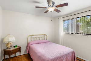 Bedroom featuring dark hardwood / wood-style floors and ceiling fan