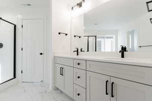 Bathroom with vanity and an enclosed shower