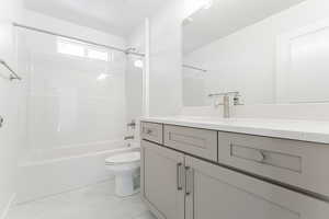 Full bathroom with vanity, shower / bathtub combination, and toilet