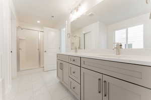 Bathroom featuring vanity and a shower with shower door