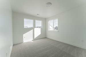 Empty room with light colored carpet