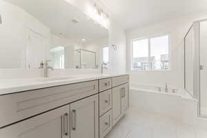 Bathroom with vanity and plus walk in shower