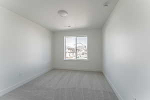 Unfurnished room featuring carpet flooring and a textured ceiling