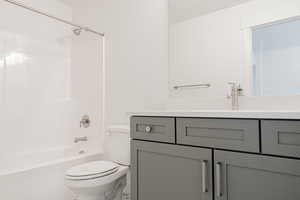 Full bathroom with vanity, toilet, and shower / washtub combination