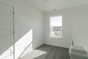 Empty room featuring dark colored carpet