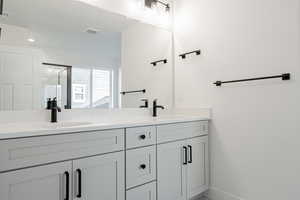 Bathroom featuring vanity and a shower with shower door