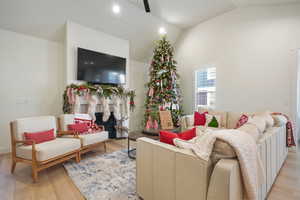 Living room featuring light wood-type flooring and lofted ceiling