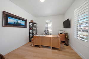 Office with light wood-type flooring