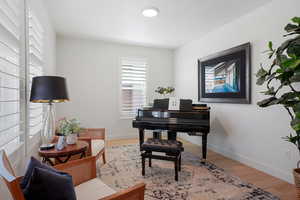 Office area with hardwood / wood-style flooring