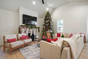 Living room featuring light hardwood / wood-style floors and lofted ceiling