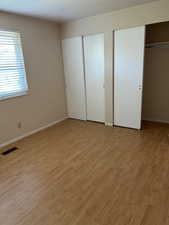 Features pergo flooring, and two closets