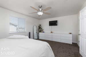 Carpeted bedroom with ceiling fan