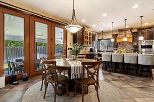 Tiled dining area featuring a healthy amount of sunlight