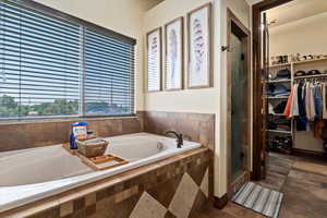 Bathroom with tile patterned flooring and plus walk in shower