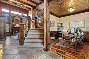 Interior space featuring hardwood / wood-style flooring, ornamental molding, a fireplace, and ceiling fan