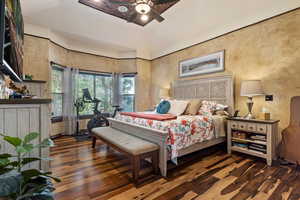 Bedroom with ceiling fan and hardwood / wood-style floors