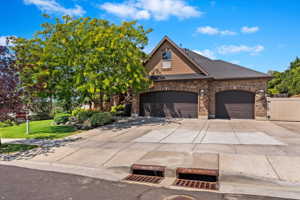 View of front of property with a garage and a front yard