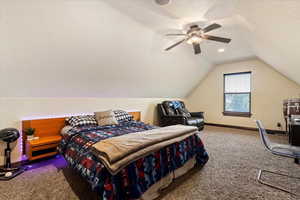 Bedroom featuring carpet, ceiling fan, vaulted ceiling, and baseboard heating