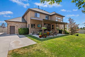 View of front of house with a patio and a front yard