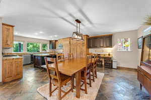 Dining room with a wealth of natural light and dark tile patterned flooring