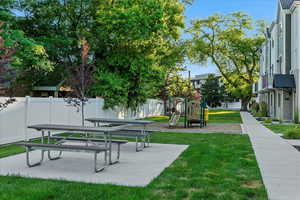 Surrounding community with a yard and a playground