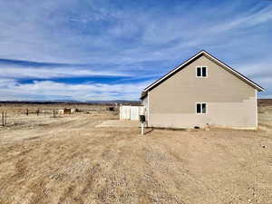 View of property exterior featuring a patio and a rural view