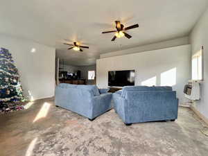 Living room with heating unit and ceiling fan