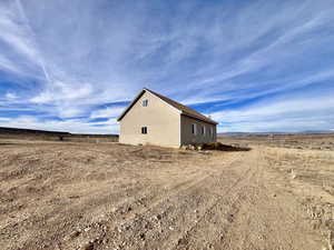 View of side of property with a rural view