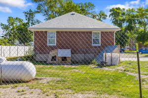 View of side of home with a lawn