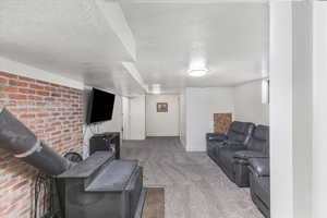 Carpeted living room with a textured ceiling