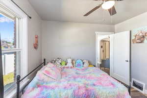 Bedroom with ceiling fan and wood-type flooring