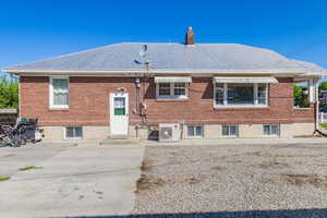 Back of house with a patio