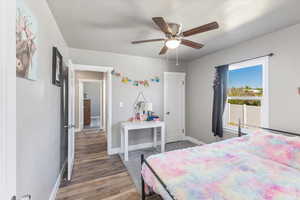 Bedroom with hardwood / wood-style flooring and ceiling fan