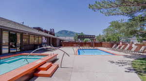 View of swimming pool featuring a pergola, a patio area, and a mountain view