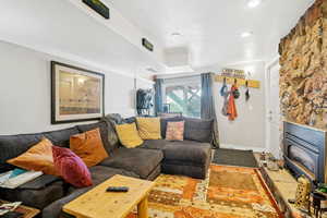 Living room with a textured ceiling and a large fireplace