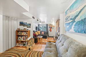 Living room with a textured ceiling and wood-type flooring