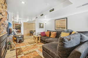 Living room featuring a textured ceiling and light hardwood / wood-style flooring