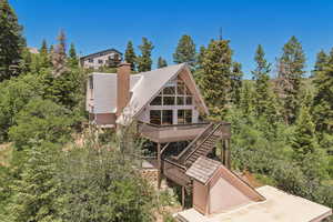 Rear view of property featuring a deck